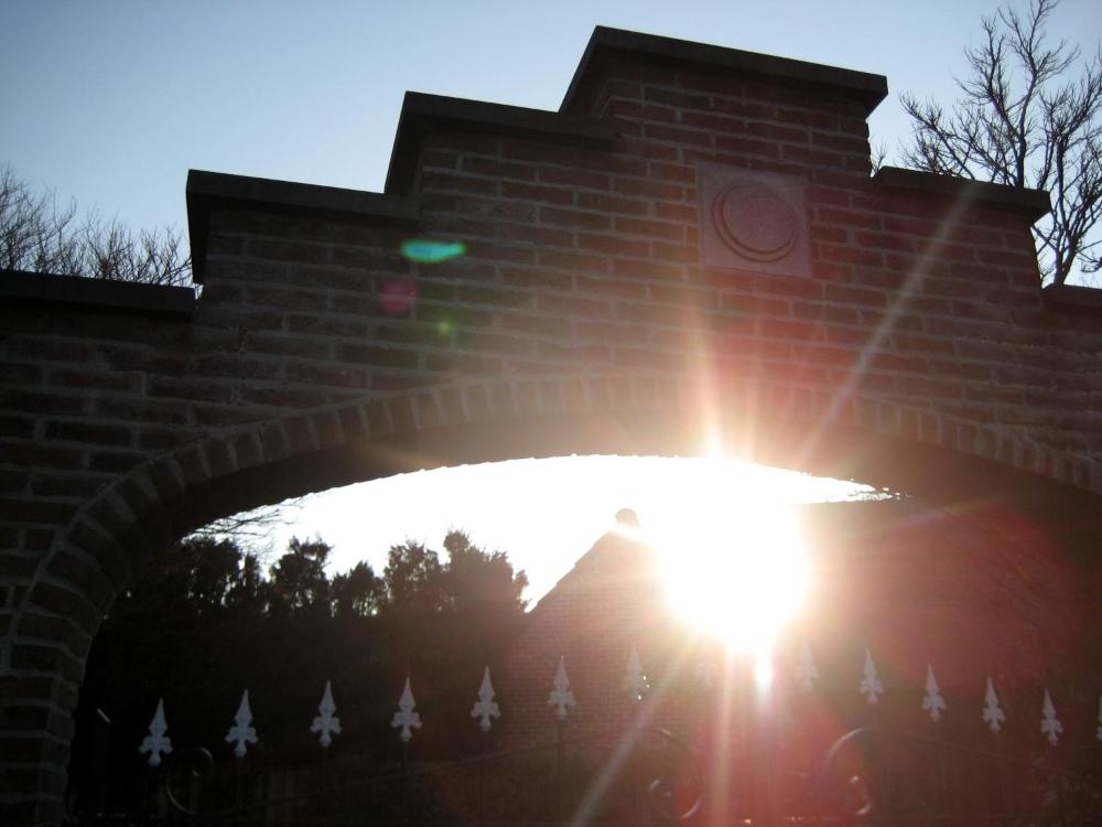 Sunlight through the brick gateway at Hotel Plaza Lommel